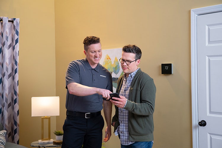 airquest-dealer-showing-man-smart-thermostats